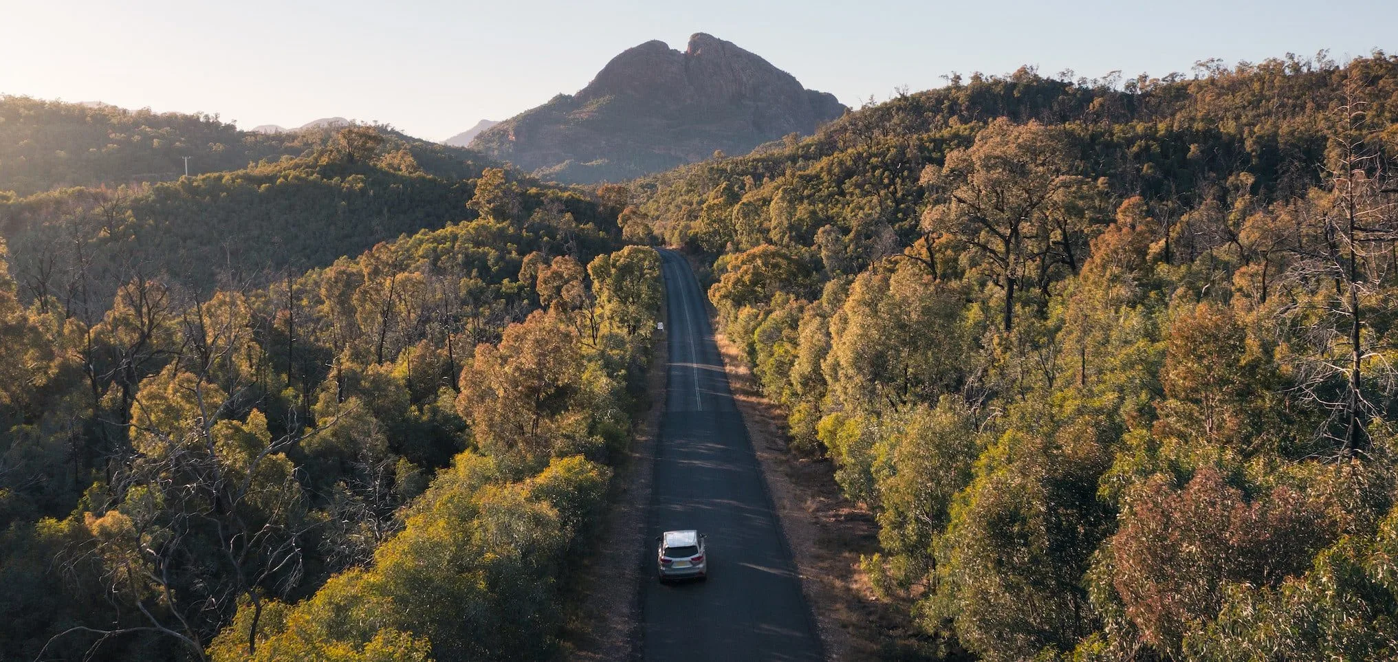 Scenic drive into Warrumbungle National Park with views through to Belougery Split Rock.